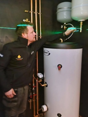 Tom Newman carrying out checks on the QR2 hot water cylinder installed in his home