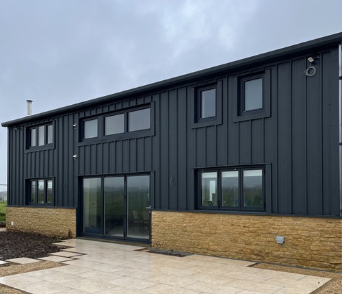 The rear of the self build barn in Wiltshire with a renewable Grant heating system